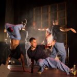 Groupe d’artistes en mouvement sur scène dans le spectacle Déséquilibré